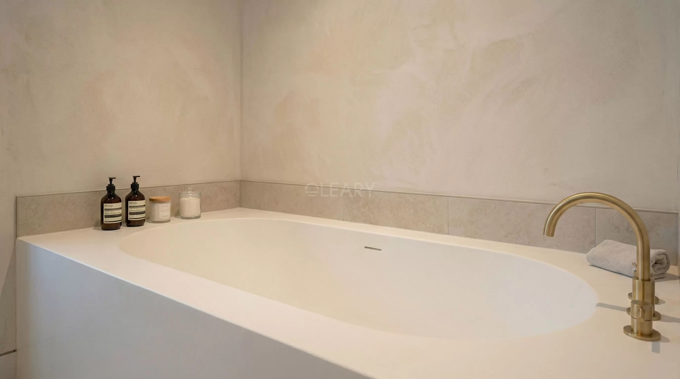 High-End Boutique Hotel Bathroom Renovation Modern boutique hotel suite featuring an elegant white solid surface freestanding bathtub, double vanity, and glass partition design